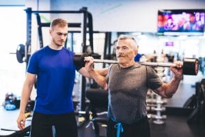 personal trainer with older client