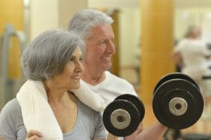 mature couple at the gym working out together
