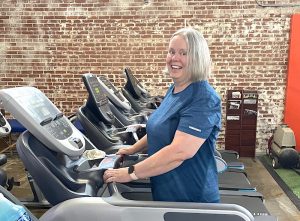midlife woman smiling on treadmill