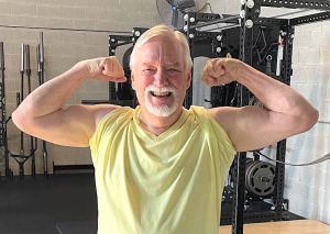 older man flexing biceps