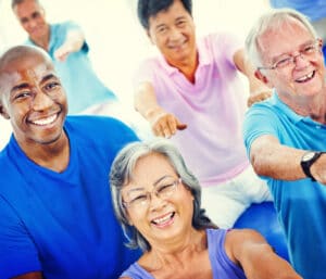 smiling older adults exercising