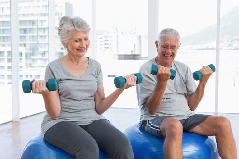 senior couple lifting weights