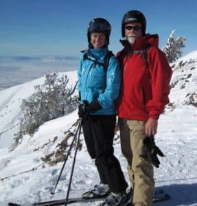 mature couple on skis in the mountains
